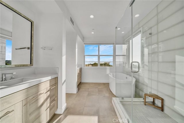 bathroom featuring tile patterned flooring, shower with separate bathtub, and vanity