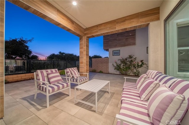 patio terrace at dusk featuring an outdoor hangout area