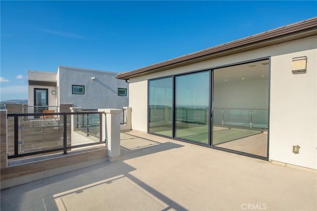 view of patio featuring a balcony