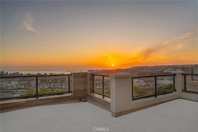 balcony at dusk with a water view