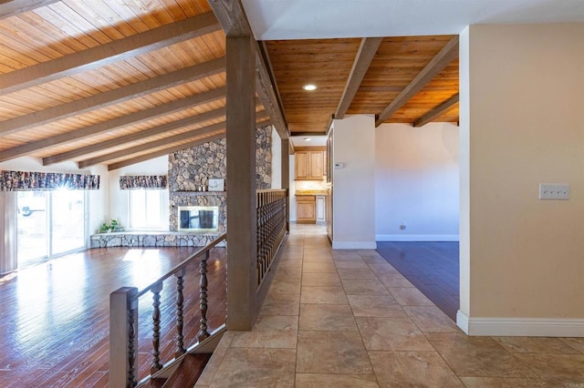 hall with vaulted ceiling with beams, light hardwood / wood-style floors, and wood ceiling