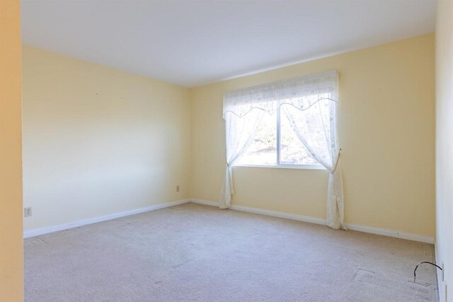 spare room with light colored carpet