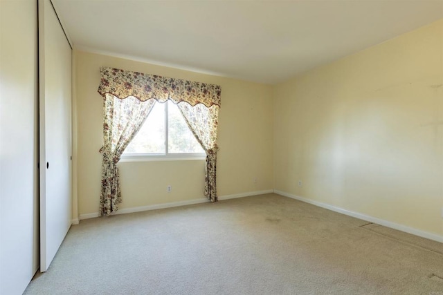 spare room with light colored carpet