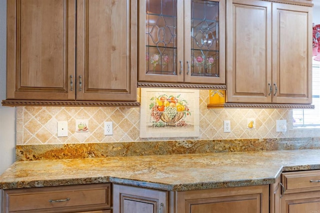 kitchen with decorative backsplash and light stone counters