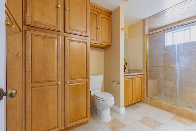 bathroom featuring an enclosed shower, vanity, toilet, and tile patterned floors