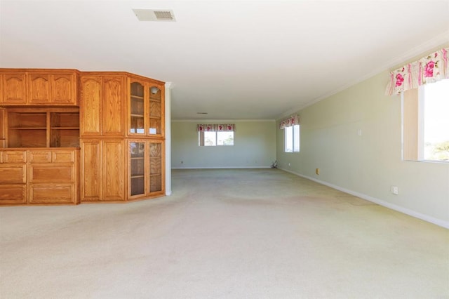 unfurnished living room with light colored carpet and ornamental molding