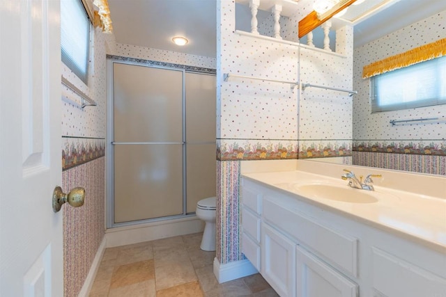 bathroom with vanity, toilet, and an enclosed shower