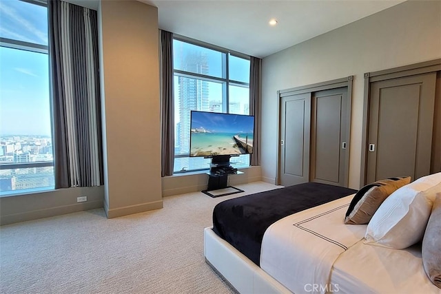 bedroom featuring light colored carpet