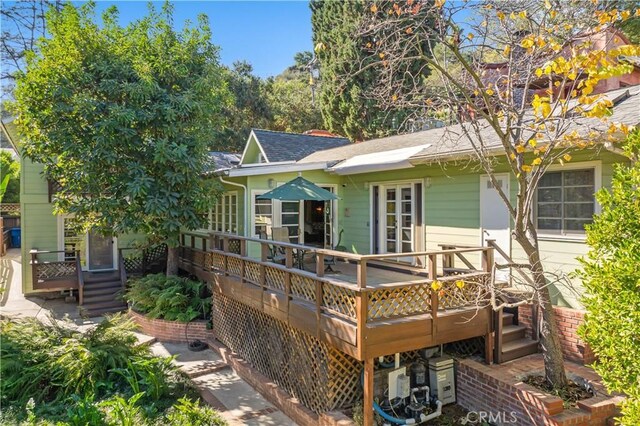 rear view of property with a wooden deck