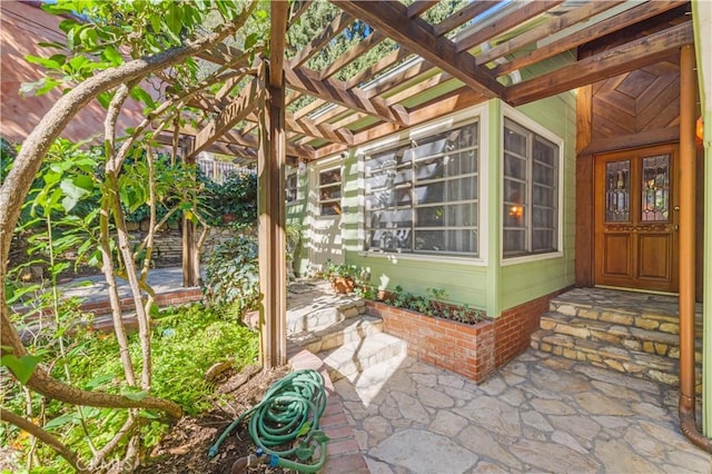 doorway to property with a pergola