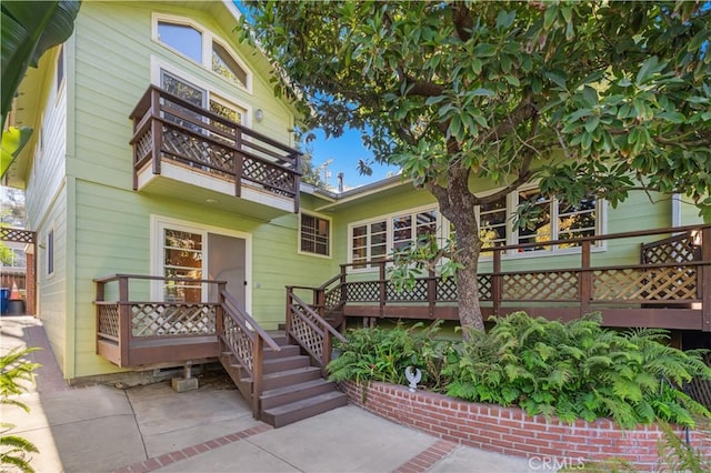 back of house featuring a balcony and a patio area