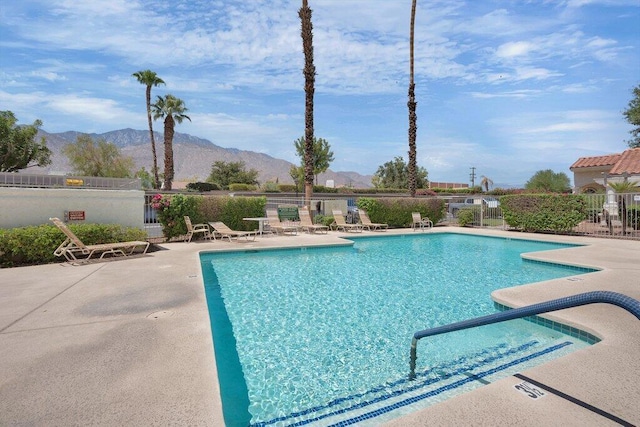 view of pool with a mountain view and a patio area