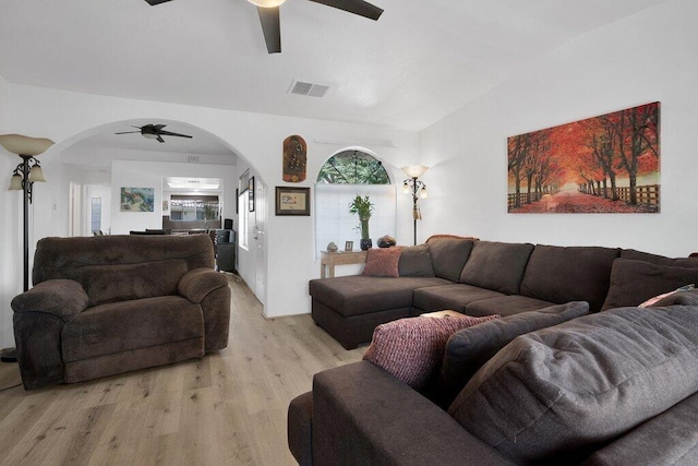 living room with ceiling fan, light hardwood / wood-style flooring, and lofted ceiling