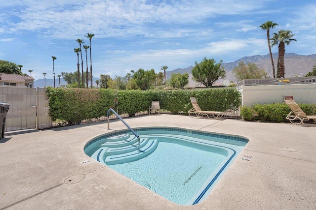 view of pool featuring a mountain view and a patio