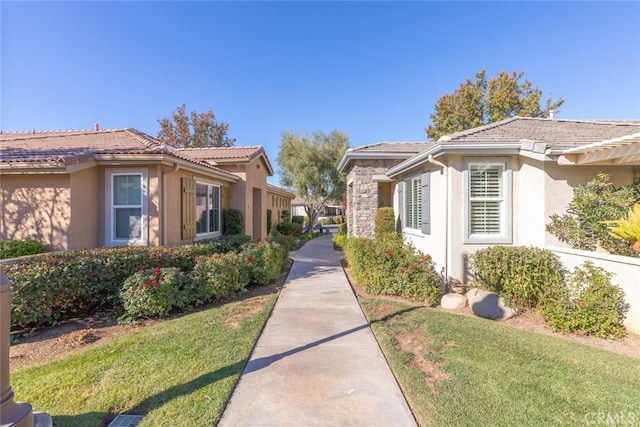 view of property exterior with a yard