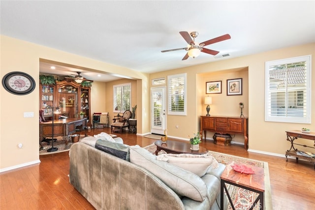 living room featuring hardwood / wood-style flooring and ceiling fan