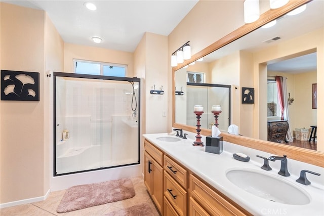 bathroom featuring tile patterned flooring, vanity, and a shower with door