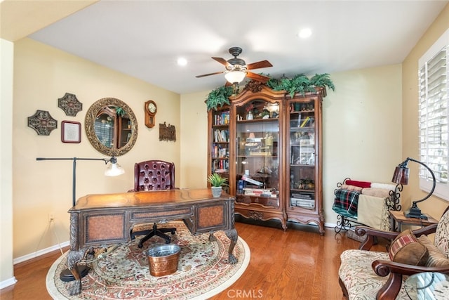 office space featuring dark hardwood / wood-style flooring and ceiling fan