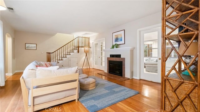 living room featuring wood-type flooring and a fireplace