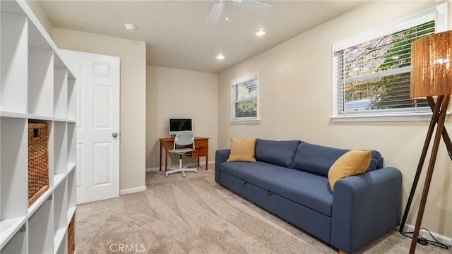 carpeted living room with ceiling fan