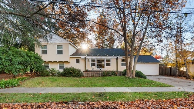 view of front of home featuring a garage and a front lawn