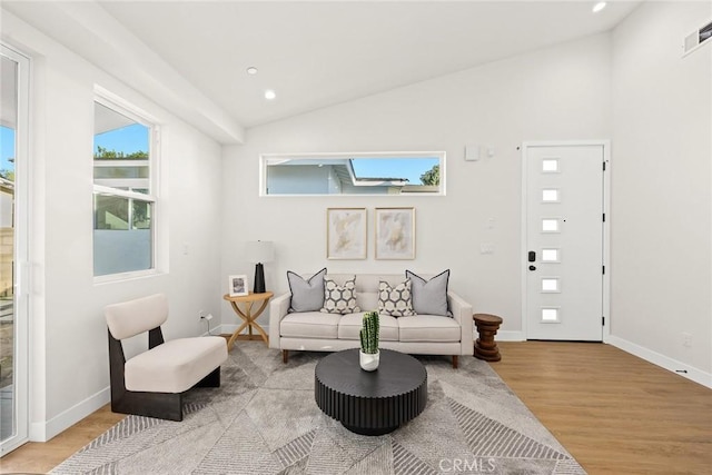 living room with lofted ceiling and light wood-type flooring