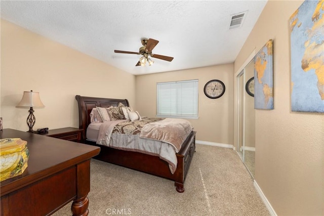 bedroom featuring light colored carpet and ceiling fan