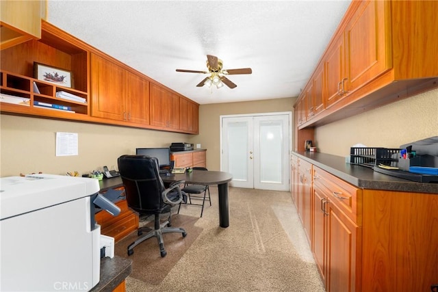 office area featuring light carpet and ceiling fan