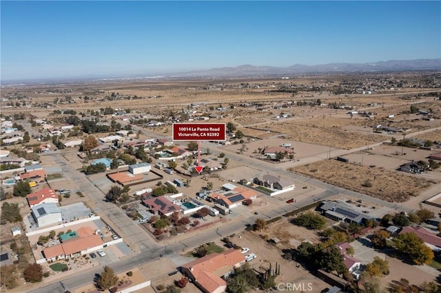 birds eye view of property featuring a mountain view