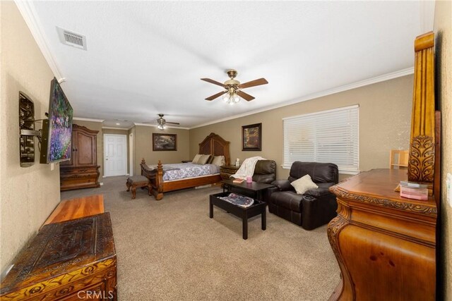 carpeted bedroom with ceiling fan and ornamental molding