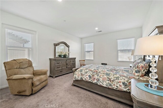 bedroom featuring light colored carpet