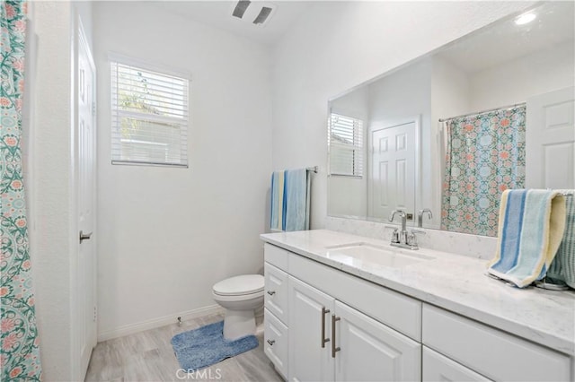 bathroom with vanity, hardwood / wood-style floors, and toilet