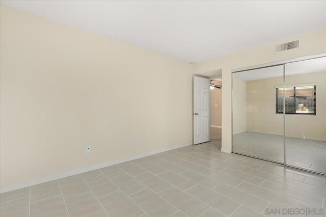 unfurnished bedroom featuring a closet and light tile patterned floors