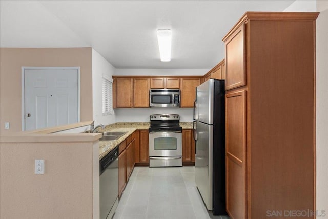 kitchen featuring kitchen peninsula, appliances with stainless steel finishes, and sink