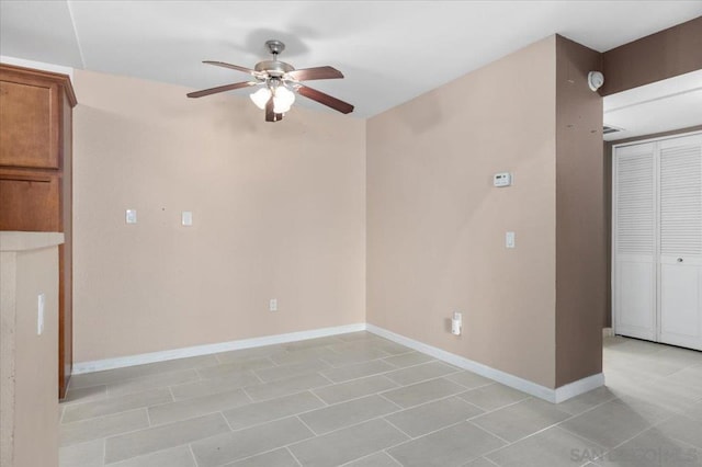 tiled empty room with ceiling fan