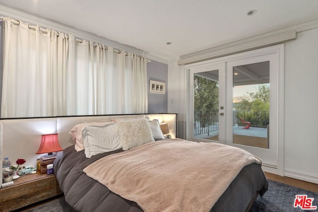 bedroom with access to outside, french doors, dark wood-type flooring, and ornamental molding