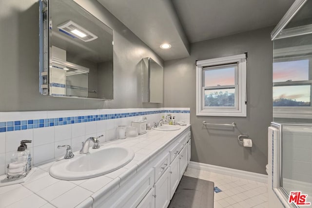 bathroom featuring vanity, tile patterned floors, and backsplash