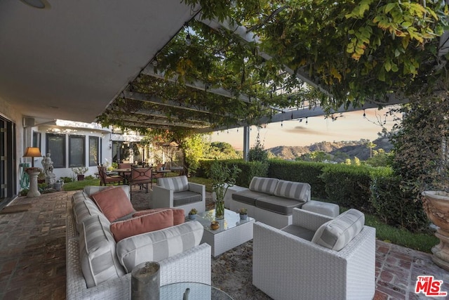 patio terrace at dusk featuring an outdoor hangout area