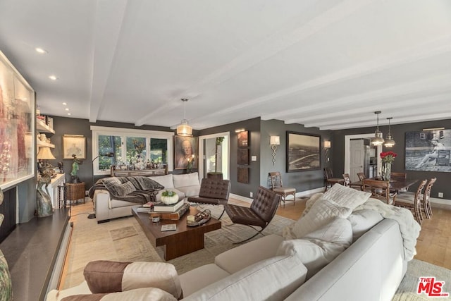 living room with beamed ceiling and light hardwood / wood-style floors