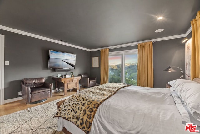 bedroom with wood-type flooring and crown molding