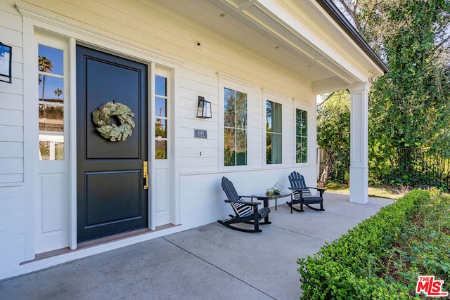 doorway to property featuring covered porch