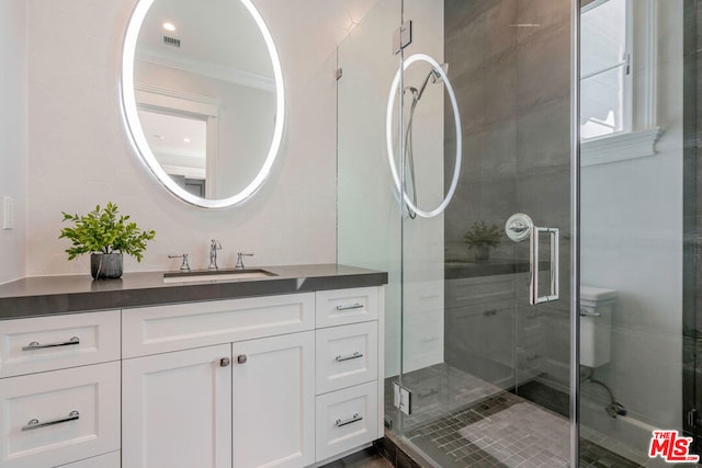 bathroom featuring vanity, walk in shower, and crown molding