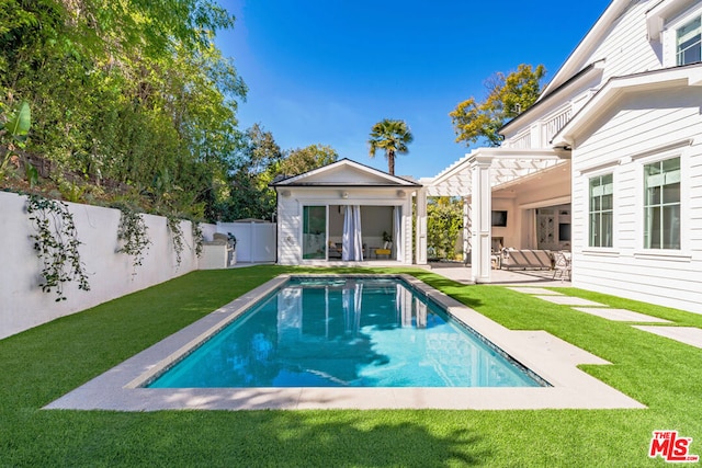 view of swimming pool with an outdoor living space, a yard, and a patio