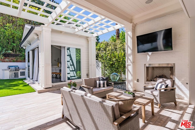 view of patio featuring an outdoor living space with a fireplace, a deck, a pergola, and grilling area