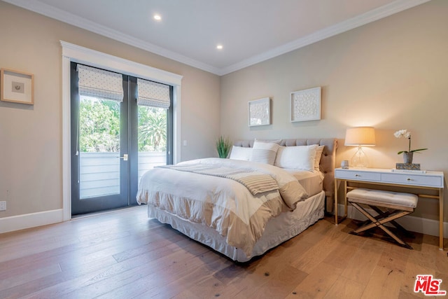 bedroom with hardwood / wood-style floors, ornamental molding, and access to outside