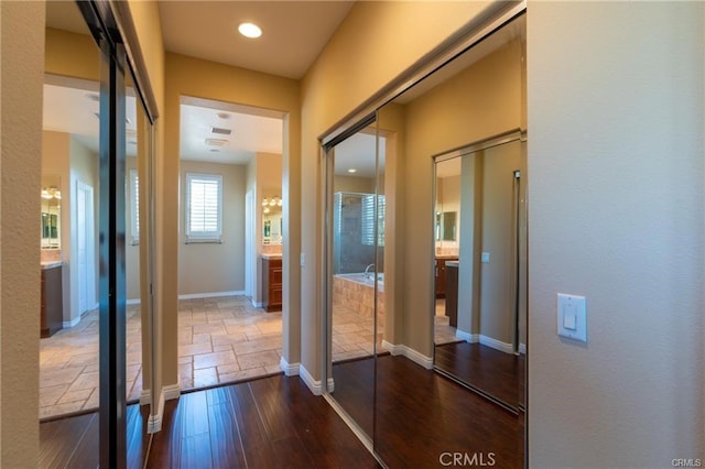 hallway with dark hardwood / wood-style flooring