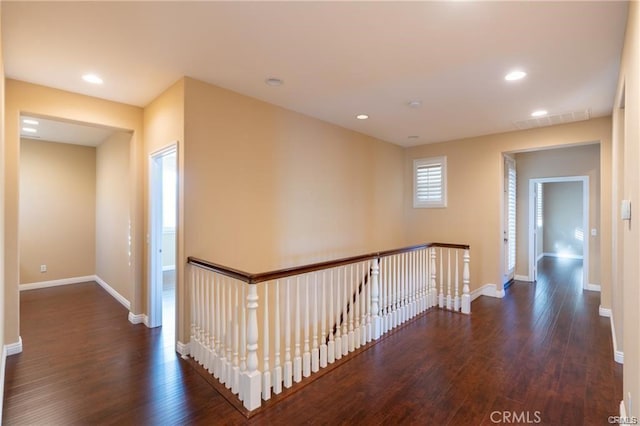 corridor with dark hardwood / wood-style flooring