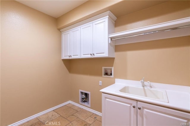 washroom with cabinets, sink, and washer hookup