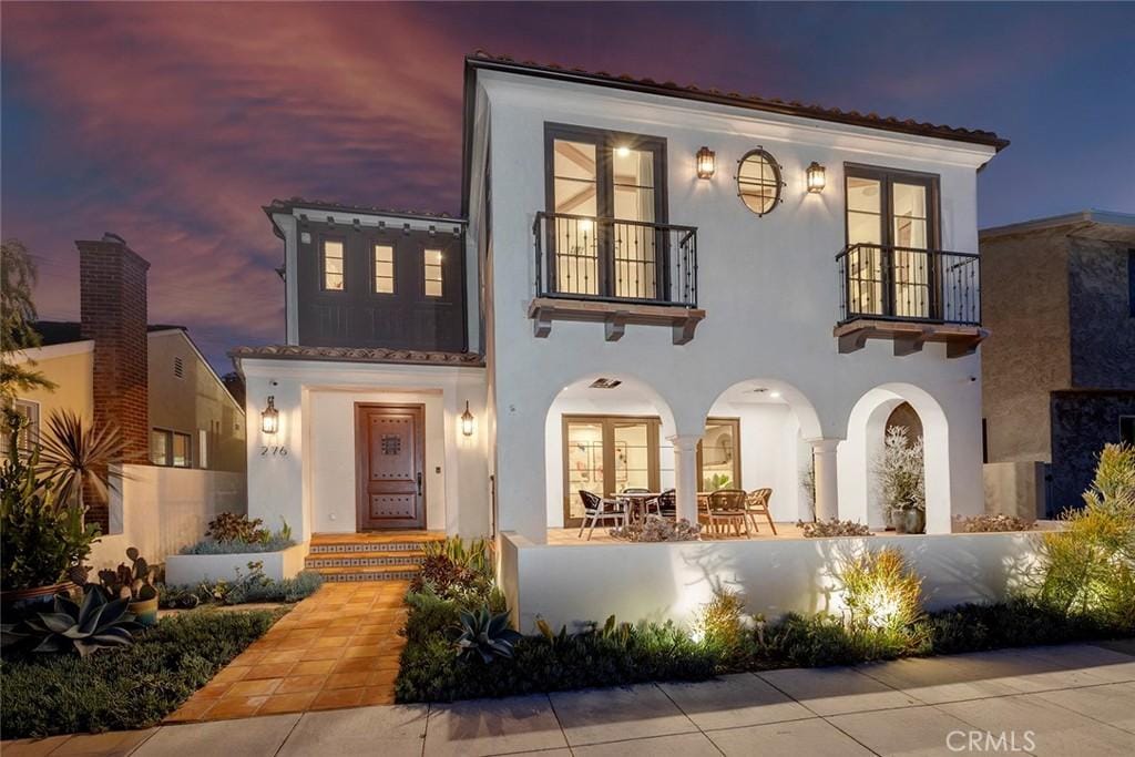 mediterranean / spanish house featuring a balcony and a patio