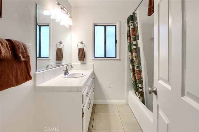 bathroom featuring tile patterned flooring, vanity, and shower / tub combo